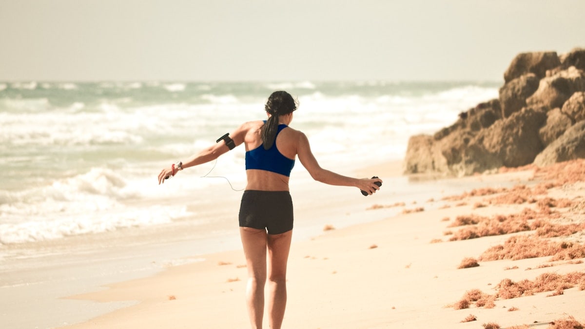 She looks like she’s enjoying the music playing as she walks the beach.